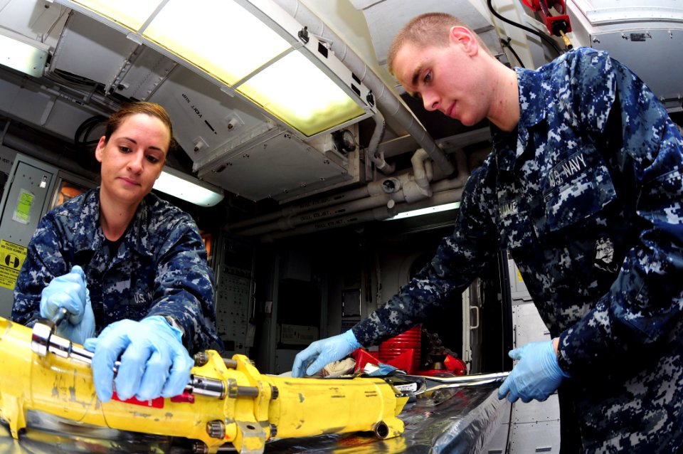 US Navy 110401-N-DM338-072 Sailors tighten an actuator assembly for an F-A-18 in the hydraulic shop aboard the aircraft carrier USS Ronald Reagan (