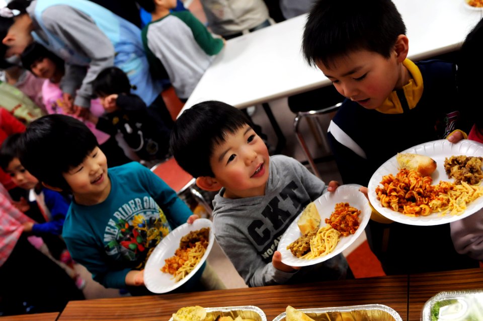 US Navy 110327-N-MU720-046 Children laugh as they wait in line for a home cooked meal at the Biko-en Children's Care House