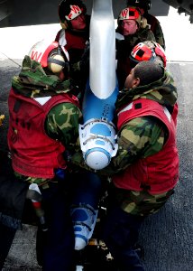 US Navy 110402-N-SG869-033 Sailors assigned to Strike Fighter Squadron (VFA) 147 load training ordnance onto an F-A-18E Super Hornet