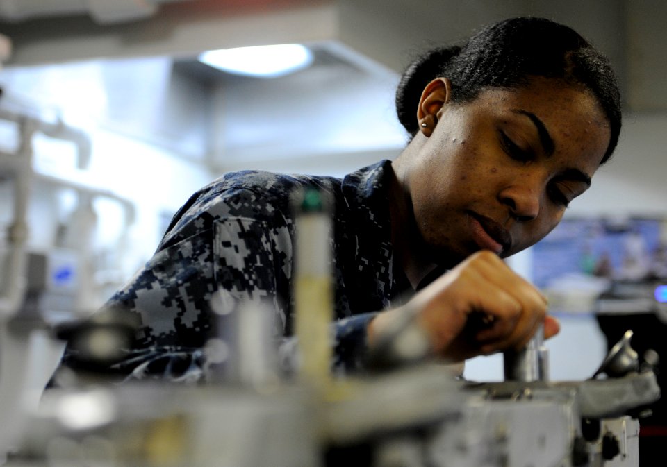 US Navy 110328-N-8040H-137 Aviation Ordnanceman Airman Diesha Ronaldson performs maintenance on a bomb rack