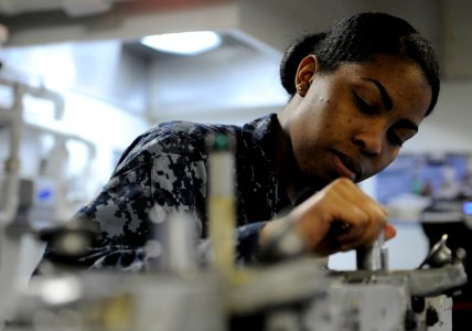 US Navy 110328-N-8040H-137 Aviation Ordnanceman Airman Diesha Ronaldson performs maintenance on a bomb rack