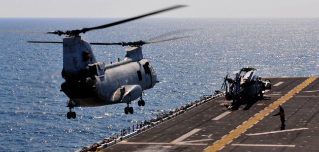 US Navy 110329-N-5538K-217 A CH-46E Sea Knight helicopter carrying humanitarian assistance supplies takes off from the forward-deployed amphibious