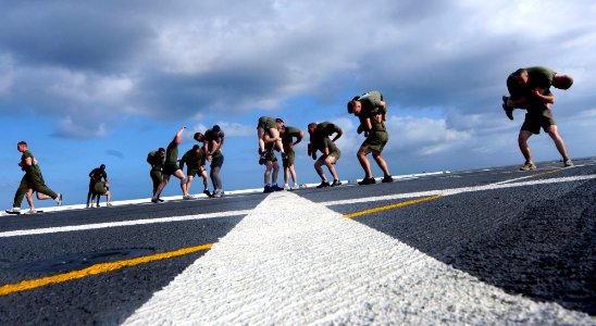 US Navy 110404-N-OS574-010 Marines participate in group physical training on the flight deck of the San Antonio-class amphibious transport dock shi