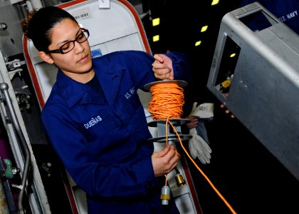 US Navy 110405-N-3154P-155 Damage Controlman Fireman Vanessa Duenas unrolls cable for a sound-powered phone during a toxic gas damage control train