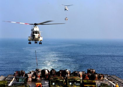 US Navy 110331-N-OM503-085 Two SA-330J Puma helicopters deliver 117 pallets of supplies to USS Harpers Ferry (LSD 49)