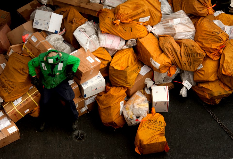 US Navy 110404-N-DR144-304 A Sailor waits to move mail below decks after it was received via carrier onboard delivery aboard USS Carl Vinson (CVN 7