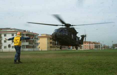US Navy 110401-N-GT324-015 A Sailor signals an Italian helicopter during the arrival of the Honorable Guido Crosetto, Under Secretary of Defense of photo