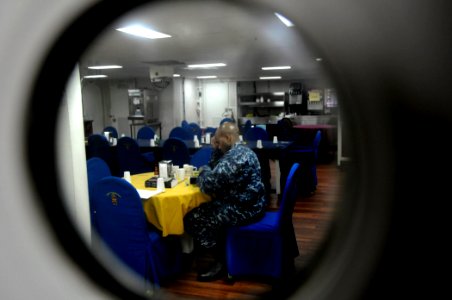 US Navy 110405-N-5716H-376 Lt. K. Madison Carter prepares the ship's evening prayer in a wardroom aboard USS Tortuga (LSD 46)