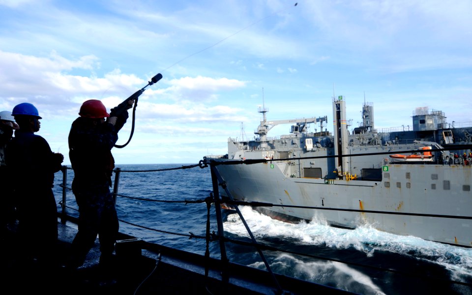 US Navy 110405-N-OS574-012 Sailors shoot across a shot line on the boat deck of USS Mesa Verde (LPD 19) during a replenishment at sea with USNS Sa