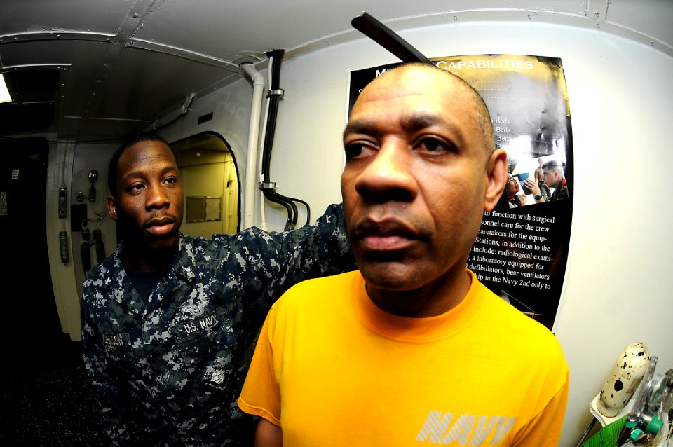 US Navy 110406-N-2908M-020 Aviation Boatswain's Mate (Handling) 3rd Class Autuan Johnson, left, measures Aviation Support Equipment 1st Class Josep
