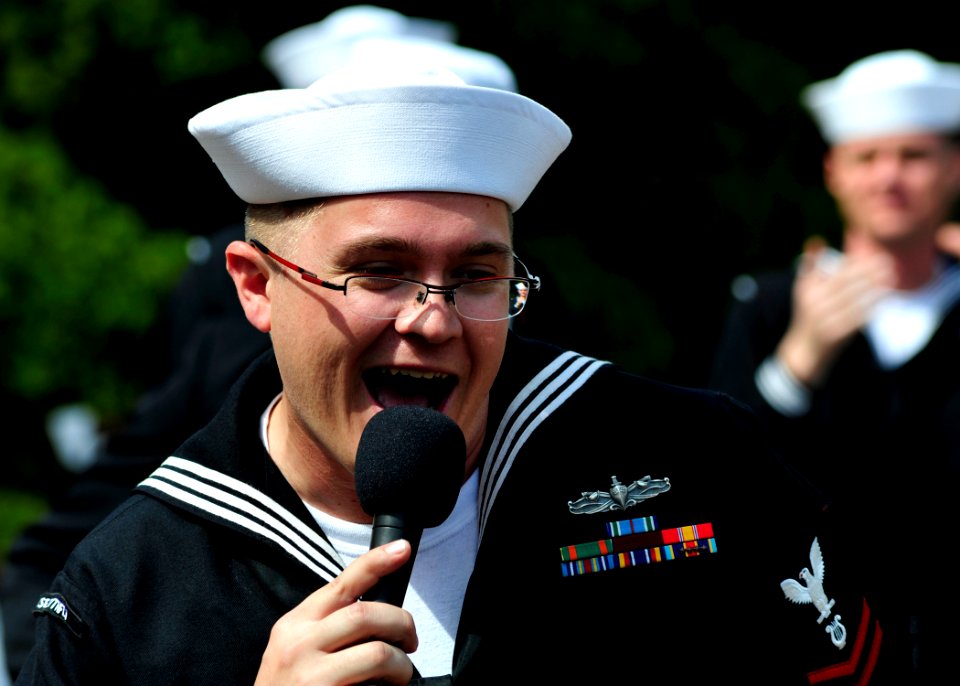 US Navy 110406-N-RO948-104 Musician 2nd Class Charles Perks sings as the U.S. 7th Fleet Band performs at a city park while on tour in the Republic
