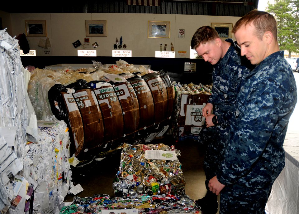US Navy 110405-N-ZK021-003 Naval Air Crewman Airman Francesco Schittinu and Naval Air Crewman Airman Steve Platt look through recyclable materials