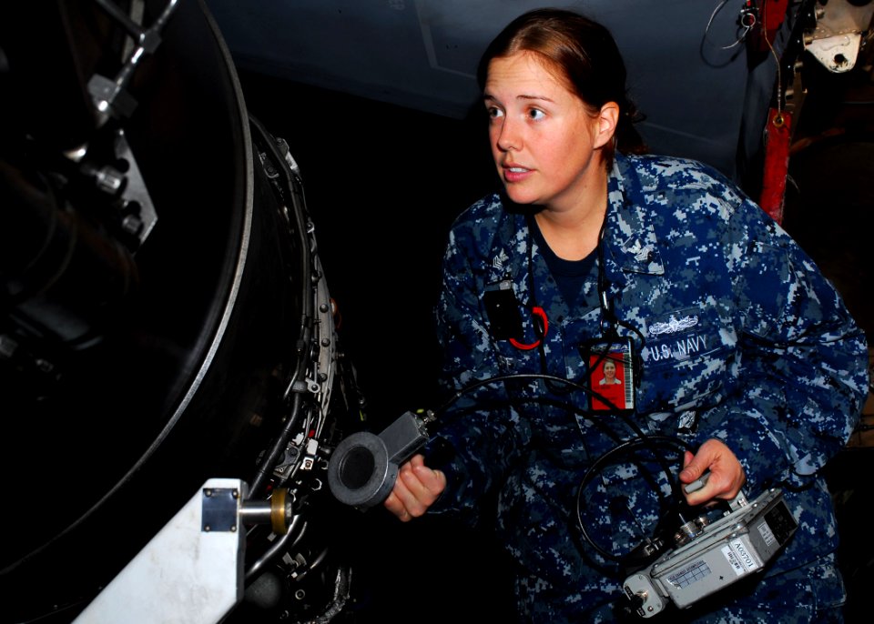 US Navy 110401-N-GL340-046 Machinist's Mate 1st Class Margaret Huff checks a jet engine for radiation