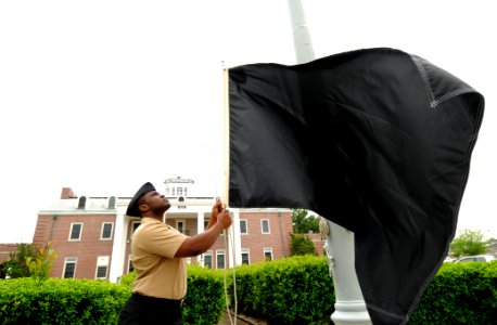 US Navy 110404-N-5328N-473 nformation Systems Technician Seaman Levert Hudson, from Indianapolis, Ind., raises a black flag to warn