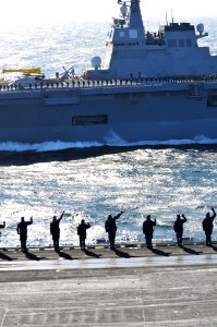 US Navy 110404-N-DM338-398 Sailors and Marines aboard USS Ronald Reagan (CVN 76) wave to Japanese sailors aboard JDS Hyuga (DDH 181) during a pass