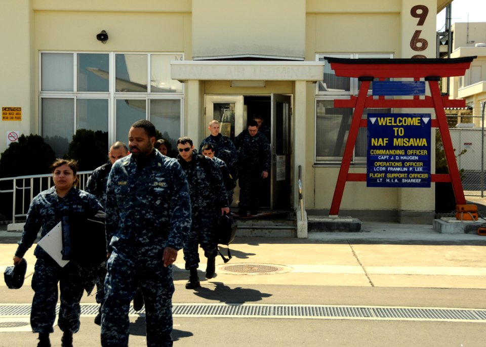 US Navy 110404-N-VA590-093 Sailors depart the Naval Air Facility (NAF) Misawa terminal as they prepare to board an airplane bound for NAF Atsugi