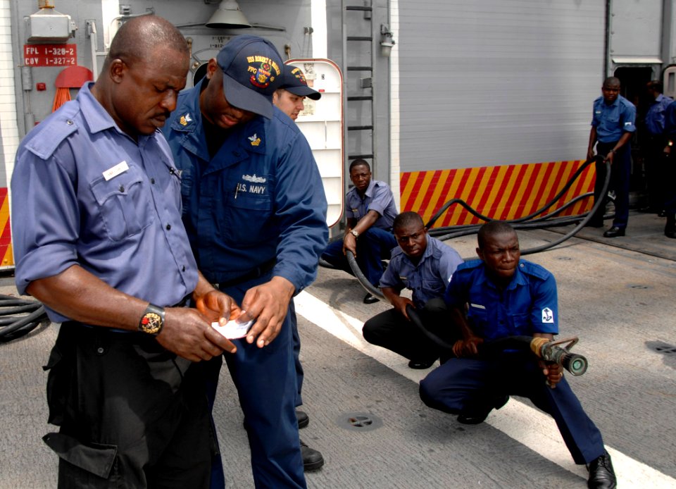 US Navy 110407-N-HI707-891 Damage Controlman 1st Class Derrick Harney teaches a Nigerian sailor about the responsibilities of an on scene leader du