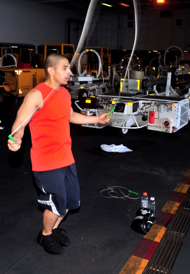 US Navy 110404-N-0074G-015 viation Ordnanceman Julian Salcido jumps rope in the hangar bay aboard USS Enterprise (CVN 65)