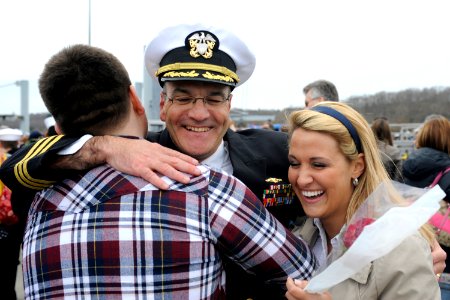 US Navy 110408-N-8467N-007 Cmdr. Raymond Gabriel hugs his son and daughter after returning form deployment
