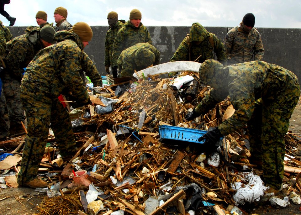 US Navy 110404-N-8607R-036 Marines assigned to the 31st Marine Expeditionary Unit (31st MEU) pick up debris on Oshima, as part of ongoing disaster