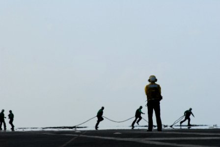 US Navy 110407-N-SB672-268 Aviation Boatswain's Mate (Handling) 3rd Class Daniel Garza, from San Antonio, looks down the landing area as Sailors re