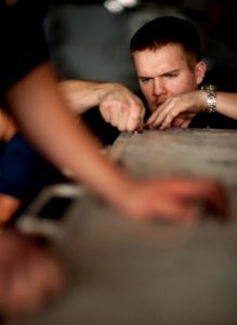 US Navy 110407-N-DR144-338 Aviation Support Equipment Technician Airman Scott Jensen secures panels after adjusting the fuel injectors on a P-25 fi