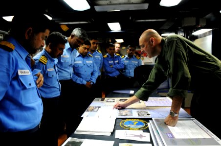 US Navy 110408-N-IC111-046 Rear Adm. Robert Girrier, commander of Carrier Strike Group (CSG) 7, explains the role of the aircraft carrier USS Ronal