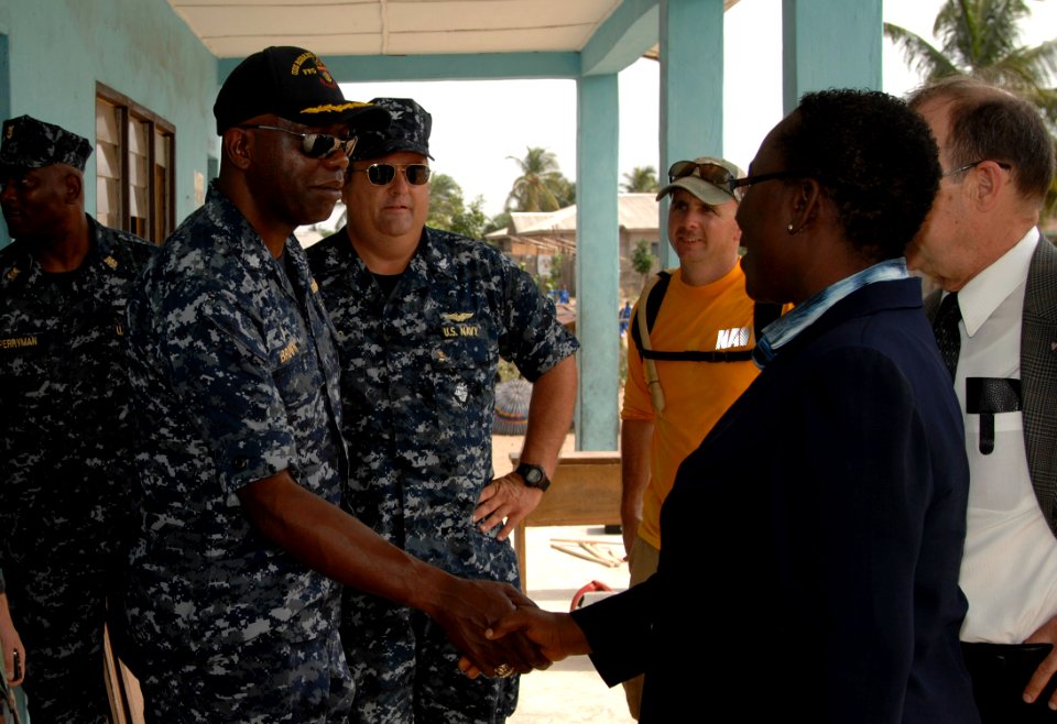 US Navy 110407-N-HI707-747 Cmdr. Darryl Brown is greeted by the director of the Light of Dawn Government Junior Secondary School Tomarow during a c