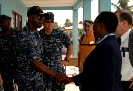 US Navy 110407-N-HI707-747 Cmdr. Darryl Brown is greeted by the director of the Light of Dawn Government Junior Secondary School Tomarow during a c