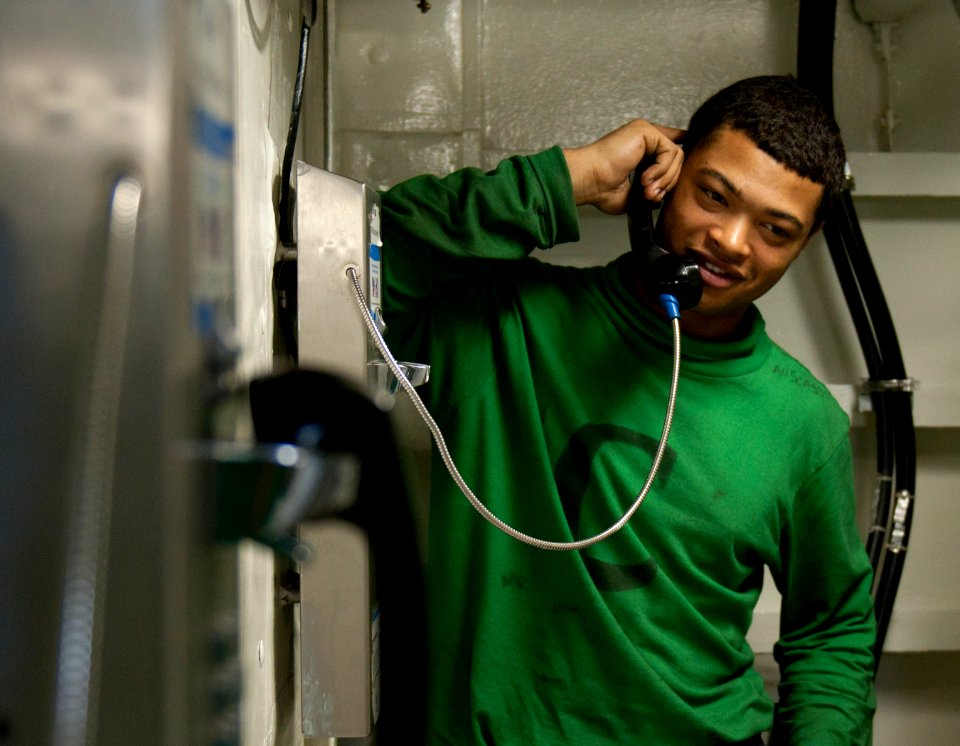 US Navy 110406-N-6505H-119 viation Boatswain's Mate (Equipment) Airman Christian Scaggs talks on a sailor phone aboard USS Carl Vinson (CVN 70)