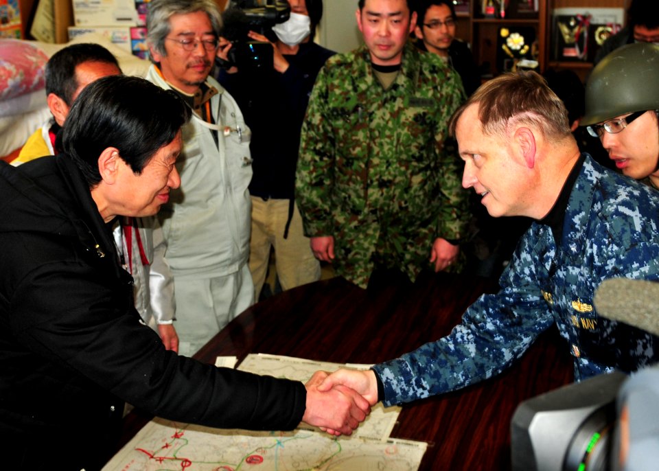 US Navy 110406-N-5538K-042 Rear Adm. Jeffery S. Jones shakes hands with Yuji Shirahata during a ceremony marking the end of the Essex Amphibious Re