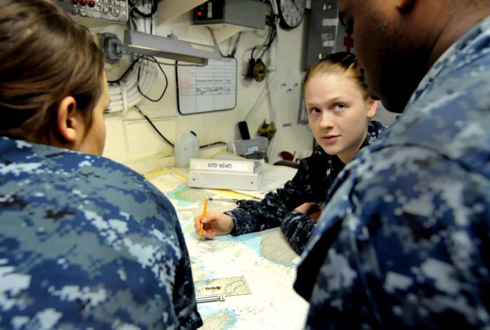 US Navy 110405-N-5716H-370 Quartermaster 3rd Class Valerie Slaughter, center, trains Quartermaster Seaman Tailor Guy and Quartermaster Seaman Jarri