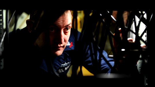 US Navy 110406-N-OY799-162 Information Systems Technician 2nd Class Christopher Stough, from St. Ann, Mo., inspects cables on satellite receivers i
