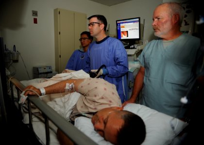 US Navy 110405-N-KA543-028 Hospitalman Urian D. Thompson, left, Lt. Cmdr. Eric A. Lavery and Registered Nurse Steven Cherry review the monitor whil