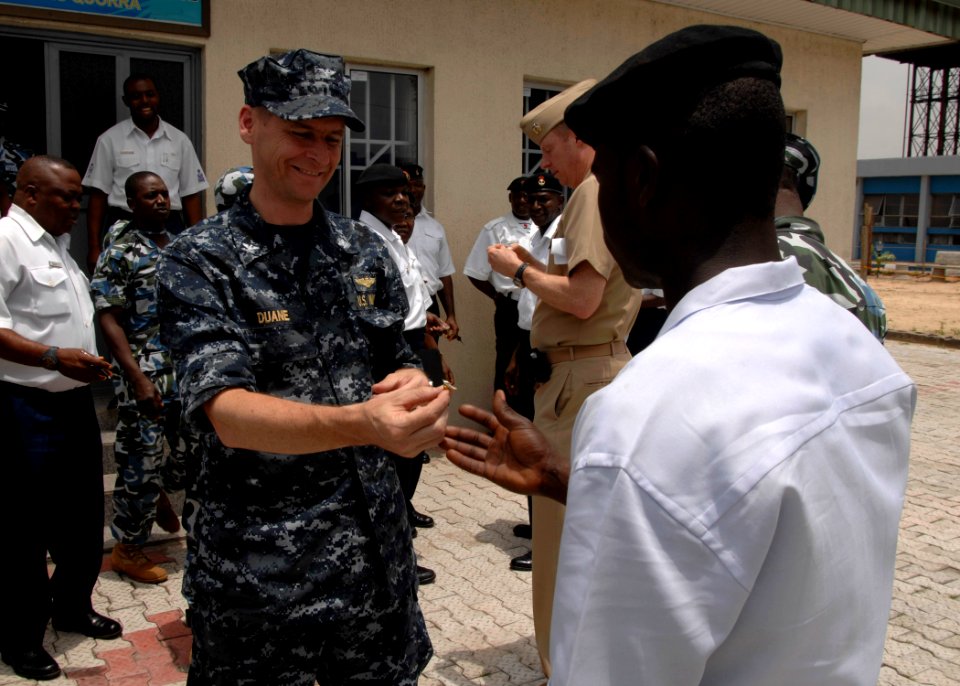 US Navy 110408-N-HI707-201 Capt. Shawn Duane presents Nigerian navy Ordinary Seaman Mohammed Nafiu with an Africa Partnership Station lapel pin aft