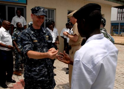 US Navy 110408-N-HI707-201 Capt. Shawn Duane presents Nigerian navy Ordinary Seaman Mohammed Nafiu with an Africa Partnership Station lapel pin aft