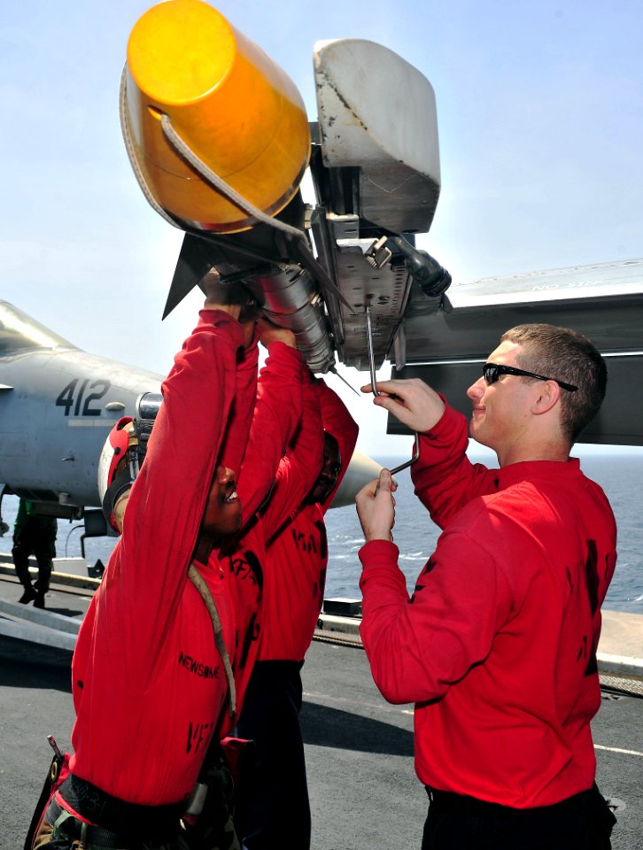 US Navy 110410-N-0074G-019 Sailors secure an aerial intercept missile to an F-A-18E Super Hornet aboard USS Enterprise (CVN 65)