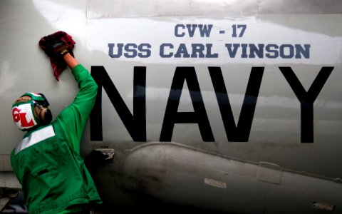 US Navy 110405-N-DR144-370 Aircrew Survival Equipmentman Airman Michael Williams cleans the fuselage of an E-2C Hawkeye aboard USS Carl Vinson (CVN