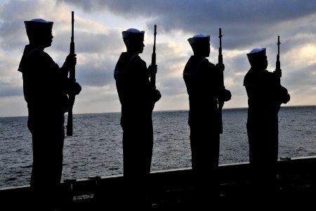 US Navy 110409-N-0074G-063 Sailors perform a gun salute during a burial at sea aboard USS Enterprise (CVN 65)