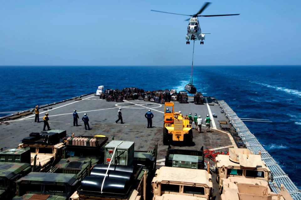 US Navy 110409-N-RC734-263 An AS332 Super Puma helicopter delivers supplies to the amphibious dock landing ship USS Comstock (LSD 45) during a vert