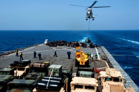 US Navy 110409-N-RC734-263 An AS332 Super Puma helicopter delivers supplies to the amphibious dock landing ship USS Comstock (LSD 45) during a vert