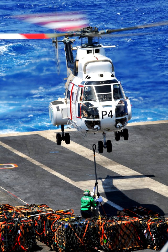 US Navy 110409-N-1004S-438 Chief Logistics Specialist Adriana Cabarcas, from Gary, Ind., attempts to connect a cargo pendant to an SA-330 Puma heli