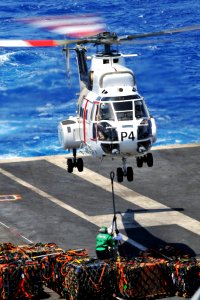 US Navy 110409-N-1004S-438 Chief Logistics Specialist Adriana Cabarcas, from Gary, Ind., attempts to connect a cargo pendant to an SA-330 Puma heli