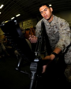 US Navy 110406-N-2908M-036 Lance Cpl. Todd checks his rifle aboard USS Kearsarge (LHD 3)