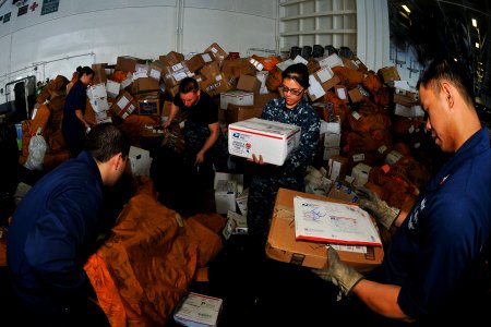 US Navy 110409-N-1004S-858 Sailors sort mail aboard the aircraft carrier USS Ronald Reagan (CVN 76). Ronald Reagan is operating in the western Paci photo