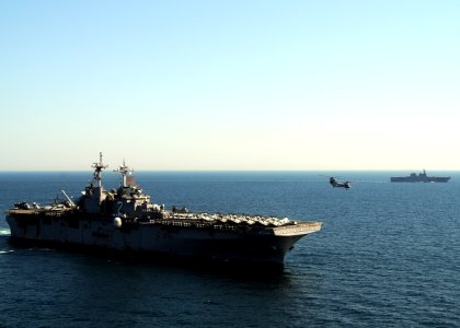 US Navy 110406-N-0120A-434 A CH-46E Sea Knight helicopter takes off from USS Essex (LHD 2) as JS Hyuga (DDH 181) transits in the background