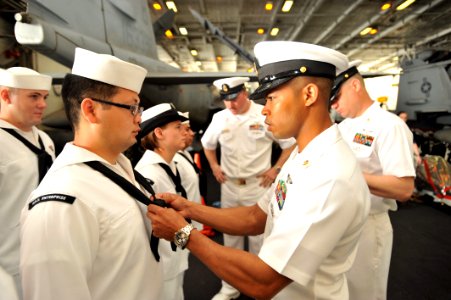 US Navy 110409-N-0569K-179 Chief Aviation Support Equipment Technician Yeri A. Jimenez, right, adjusts a neckerchief for Aviation Support Equipment