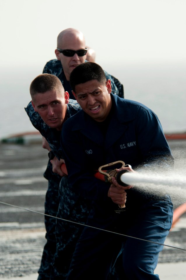 US Navy 110408-N-6505H-141 Sailors man a fire hose during Damage Control Olympics aboard USS Carl Vinson (CVN 70)