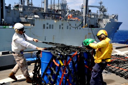 US Navy 110406-N-7293M-316 Marine Corps Gunnery Sgt. Matthew Blais, left, and Aviation Boatswain's Mate (Handling) 1st Class Jesse Seagrave secure