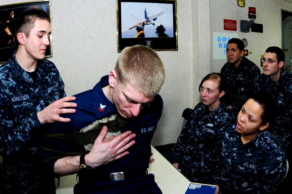 US Navy 110407-N-IC111-060 Gunner's Mate Seaman Matthew Schulthess, from Santa Rosa, Calif., practices applying first aid to Gunner's Mate 2nd Clas